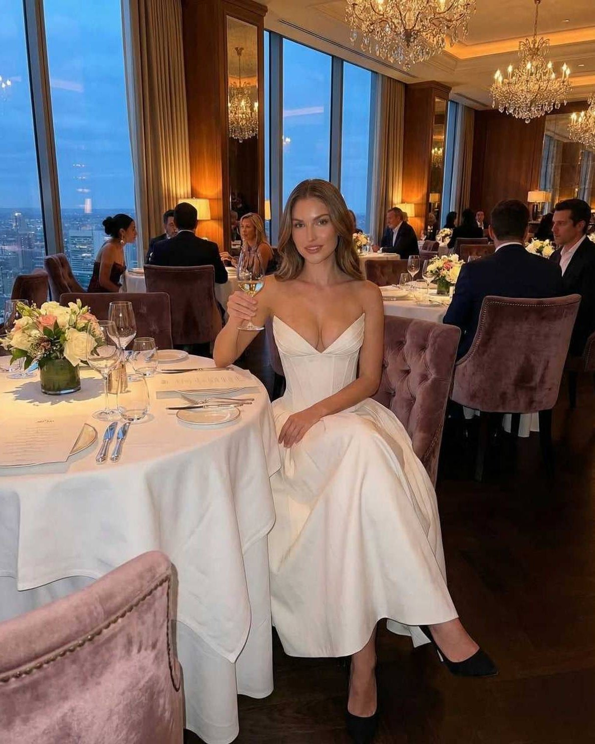 Luna Midi Dress worn at an elegant dinner, showcasing its strapless A-line silhouette and sophisticated design.