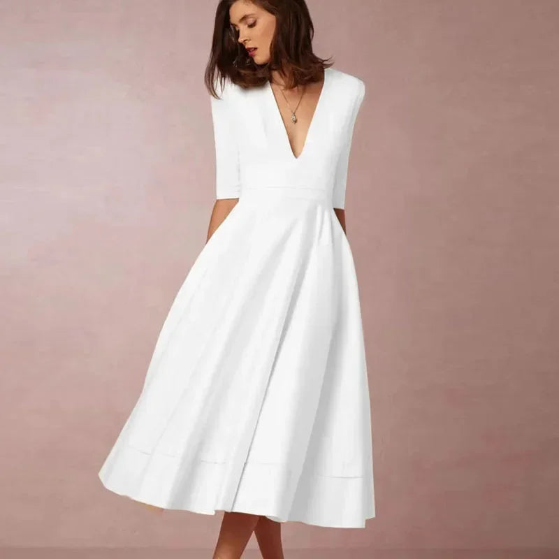 Vestido midi con falda acampanada, escote en V, mangas 3/4 y bolsillos